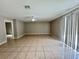 Spacious living room with tiled floors, ceiling fan and sliding glass doors at 306 Snook Way, Kissimmee, FL 34759