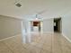 A bright, neutral living area features tiled flooring, a ceiling fan, and seamless access to the kitchen at 306 Snook Way, Kissimmee, FL 34759