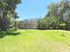 View of home's screened pool area and spacious backyard at 3100 Pine Needle Trl, Kissimmee, FL 34746