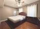 Inviting bedroom with hardwood floors and a ceiling fan at 3100 Pine Needle Trl, Kissimmee, FL 34746