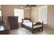 Cozy bedroom with ceiling fan, dresser, and natural light at 3100 Pine Needle Trl, Kissimmee, FL 34746