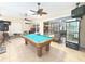 An entertainment space with a pool table, stocked fridge, and mounted tv at 3100 Pine Needle Trl, Kissimmee, FL 34746