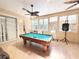 Bright game room featuring a billiard table and lots of natural light at 3100 Pine Needle Trl, Kissimmee, FL 34746