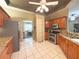 Traditional kitchen with stainless steel appliances, and a view of the dining room at 3100 Pine Needle Trl, Kissimmee, FL 34746