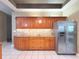 Well-lit kitchen featuring granite countertops, stainless steel appliances, and light-colored tile floors at 3100 Pine Needle Trl, Kissimmee, FL 34746
