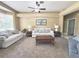 Comfortable living room with neutral carpeting, ceiling fan, and large window for natural light at 3100 Pine Needle Trl, Kissimmee, FL 34746