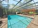 Beautiful pool area with screened enclosure and pergola-covered deck at 3100 Pine Needle Trl, Kissimmee, FL 34746