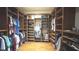 Spacious walk-in closet with custom wood shelving and wood floor offering ample storage at 3100 Pine Needle Trl, Kissimmee, FL 34746