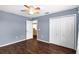 Blue bedroom featuring hardwood floors, a double door closet, and an entrance at 3131 Regal Darner Dr, Kissimmee, FL 34744