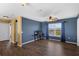 Spacious bedroom featuring a ceiling fan, hardwood floors, a view of a pond, and blue accent wall at 3131 Regal Darner Dr, Kissimmee, FL 34744