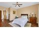 Relaxing bedroom featuring wood floors, neutral color scheme, and ample natural light at 3131 Regal Darner Dr, Kissimmee, FL 34744