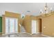 Bright foyer featuring tile flooring, high ceilings, and decorative staircase at 3131 Regal Darner Dr, Kissimmee, FL 34744