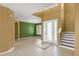 Bright foyer features tile flooring, high ceilings, and decorative staircase at 3131 Regal Darner Dr, Kissimmee, FL 34744