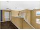 Bright upstairs hallway with hardwood floors, white trim, decorative lighting, and multiple windows at 3131 Regal Darner Dr, Kissimmee, FL 34744