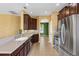 Modern kitchen featuring stainless steel appliances, tile floors, and a view of the dining area at 3131 Regal Darner Dr, Kissimmee, FL 34744