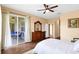 Inviting main bedroom with sliding glass doors leading to outdoor patio, wood floors, dresser at 3131 Regal Darner Dr, Kissimmee, FL 34744