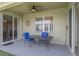 Covered patio with table and chairs, providing a comfortable outdoor space for relaxing at 3131 Regal Darner Dr, Kissimmee, FL 34744