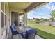 Relaxing patio with comfortable blue chairs and a table overlooking the beautiful lake view at 3131 Regal Darner Dr, Kissimmee, FL 34744