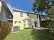 A cozy backyard featuring a lush lawn and a charming patio area with an exterior view of the house at 3352 Hamlet Loop, Winter Park, FL 32792