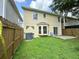 Exterior home view of a cozy backyard featuring a lush lawn, patio, and a wood fence at 3352 Hamlet Loop, Winter Park, FL 32792