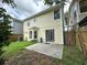 Exterior home view of a cozy backyard featuring a lush lawn, patio area, and wood fence at 3352 Hamlet Loop, Winter Park, FL 32792
