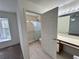 Bright bathroom featuring a shower, vanity, and a window offering natural light at 3352 Hamlet Loop, Winter Park, FL 32792