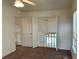 A carpeted bedroom with a ceiling fan overlooking the staircase landing at 3352 Hamlet Loop, Winter Park, FL 32792