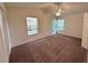 Carpeted bedroom with a ceiling fan and windows allowing natural light in at 3352 Hamlet Loop, Winter Park, FL 32792