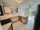Bright kitchen featuring white cabinets, tile flooring, and stainless-steel appliances at 3352 Hamlet Loop, Winter Park, FL 32792