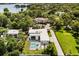 Aerial view showing private backyard with pool, spa, and modern house nestled in trees at 350 Northwind Rd, Maitland, FL 32751