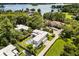 Stunning aerial view of estate home with pool, lush landscaping, and beautiful lake in the background at 350 Northwind Rd, Maitland, FL 32751