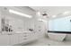 Modern bathroom with a double vanity, luxurious soaker tub, and sleek black accents at 350 Northwind Rd, Maitland, FL 32751