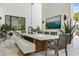 An open-air dining space featuring a long wood table, contemporary chairs, and outdoor plants at 350 Northwind Rd, Maitland, FL 32751