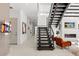 Grand foyer with dark wood staircase and contemporary art showcasing a luxurious entrance at 350 Northwind Rd, Maitland, FL 32751