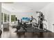 Spacious home gym featuring modern equipment and dark hardwood floors for a dedicated workout area at 350 Northwind Rd, Maitland, FL 32751