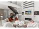Modern living room featuring soaring ceilings, open staircase, sleek fireplace, and stylish furnishings at 350 Northwind Rd, Maitland, FL 32751