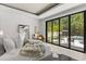 Bright main bedroom with a king-size bed, large window, and modern outdoor furniture, bringing the outdoors in at 350 Northwind Rd, Maitland, FL 32751