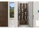 Modern wine cellar featuring glass door and wooden racks to store wine bottles at 350 Northwind Rd, Maitland, FL 32751