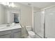 Bathroom featuring granite countertops, stainless steel faucet, walk-in shower with glass doors at 369 Ocean Course Ave, Davenport, FL 33896