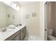 Bathroom with double sinks, marble countertops, and decorative accents at 369 Ocean Course Ave, Davenport, FL 33896
