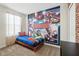 A bedroom features a twin bed with Marvel Avengers theme and wall art at 369 Ocean Course Ave, Davenport, FL 33896