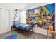A bedroom features a twin bed, carpeted floors, and Toy Story-themed decor at 369 Ocean Course Ave, Davenport, FL 33896