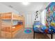 A room features a bunk bed, twin bed, carpeted floors, and Toy Story-themed decor at 369 Ocean Course Ave, Davenport, FL 33896