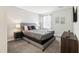 Bedroom featuring a gray bed frame, carpeted floors, two bedside tables and neutral walls at 369 Ocean Course Ave, Davenport, FL 33896