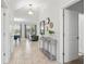 Bright and airy foyer featuring tile flooring, a decorative console table, and an open view into the living areas at 369 Ocean Course Ave, Davenport, FL 33896