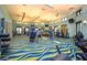 Well-equipped gym with cardio machines, weights, and a bright, airy atmosphere for workouts at 369 Ocean Course Ave, Davenport, FL 33896