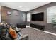 Home theater room featuring a large screen tv, leather reclining chairs, and black out blinds at 369 Ocean Course Ave, Davenport, FL 33896