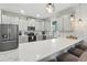 Bright kitchen featuring stainless appliances, gray cabinets and white countertops with bar stool seating at 369 Ocean Course Ave, Davenport, FL 33896