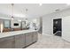 View from kitchen to living room and stairs featuring marble tile floors and an open concept layout at 369 Ocean Course Ave, Davenport, FL 33896