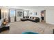 Spacious living room features a sectional sofa, neutral carpet, and lots of light from two large windows at 369 Ocean Course Ave, Davenport, FL 33896